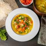 Italienische Minestrone angerichtet auf weißem Teller